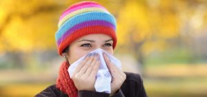 girlblowingnoseinhat-850x400